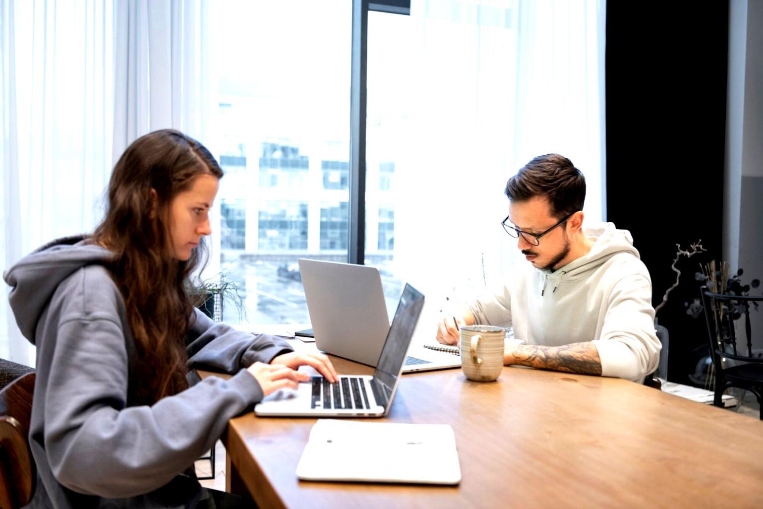 Investment analysis charts and market data displayed on multiple screens
